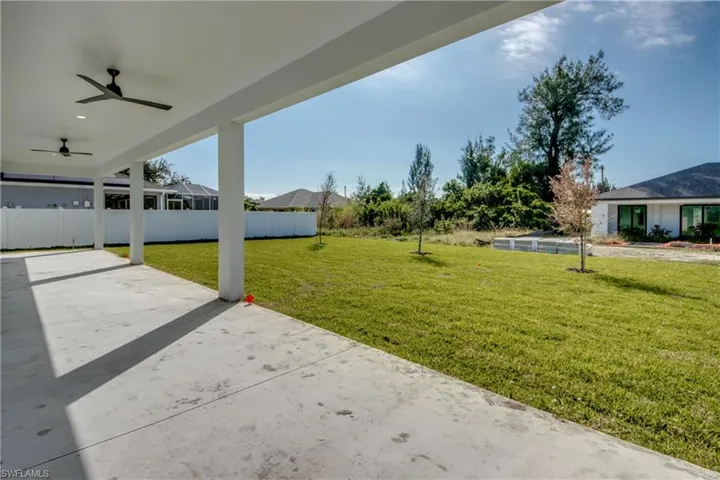 backyard with a ceiling fan and a patio area