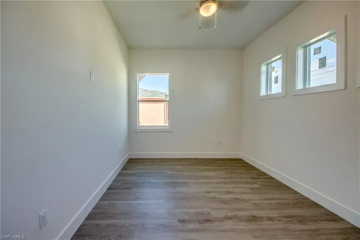 Unfurnished room featuring light wood-style floors and a ceiling fan