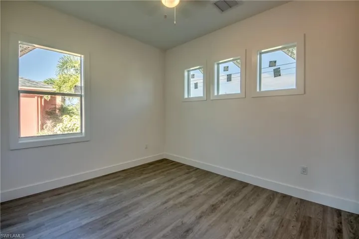 Spare room featuring wood finished floors and a ceiling fan