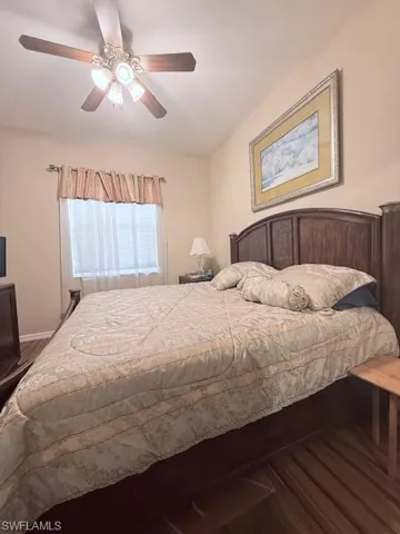 Bedroom with wood finished floors and a ceiling fan