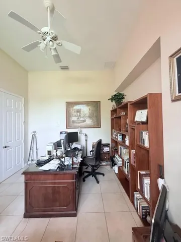 Home office featuring light tile patterned floors and a ceiling fan