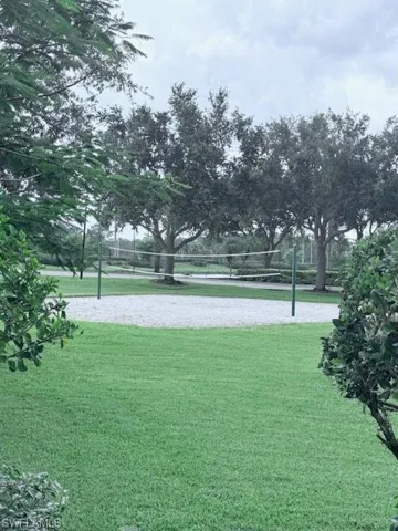 View of community featuring volleyball court and a lawn