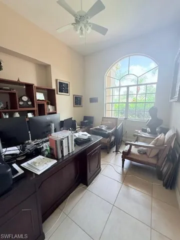Office featuring light tile patterned flooring and a ceiling fan