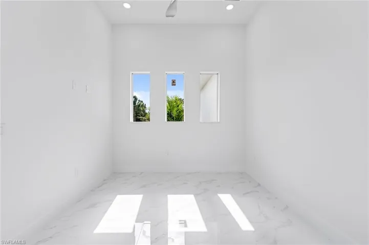 Empty room with light tile flooring