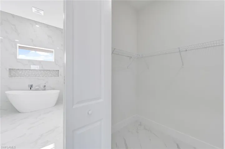 Bathroom featuring tile flooring and tile walls