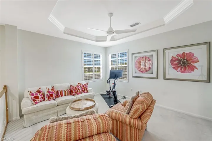 Versatile Loft Space with intricate ceiling detail, plantation shutters and plush carpet.