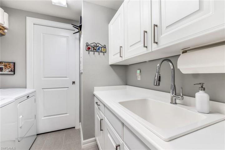 In Residence Laundry Room With Sink and Additional Cabinets