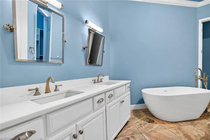 Full bath with double vanity and a freestanding bath