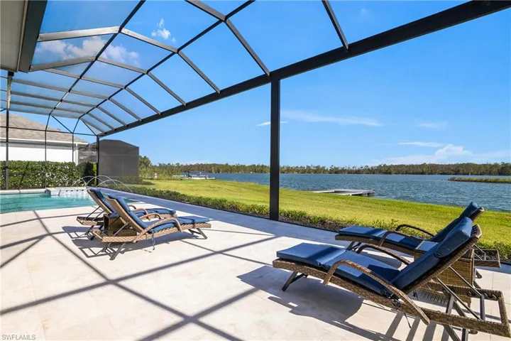 View of patio / terrace featuring glass enclosure and a water view