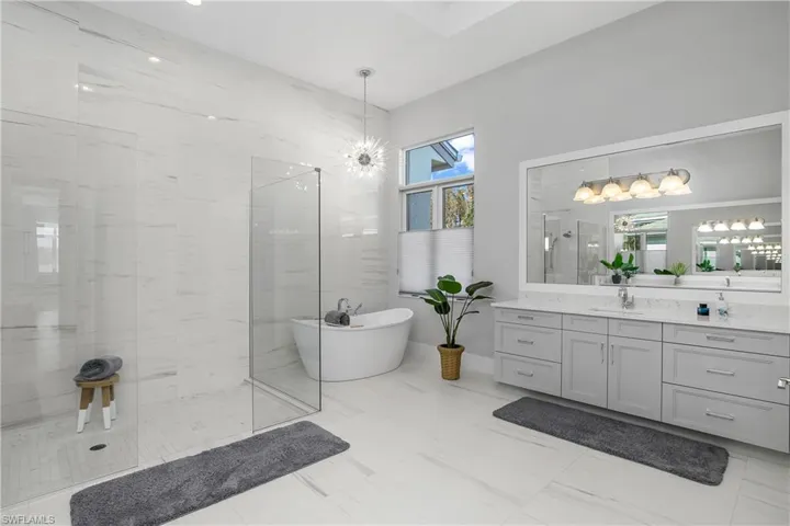 Bathroom featuring plus walk in shower and vanity