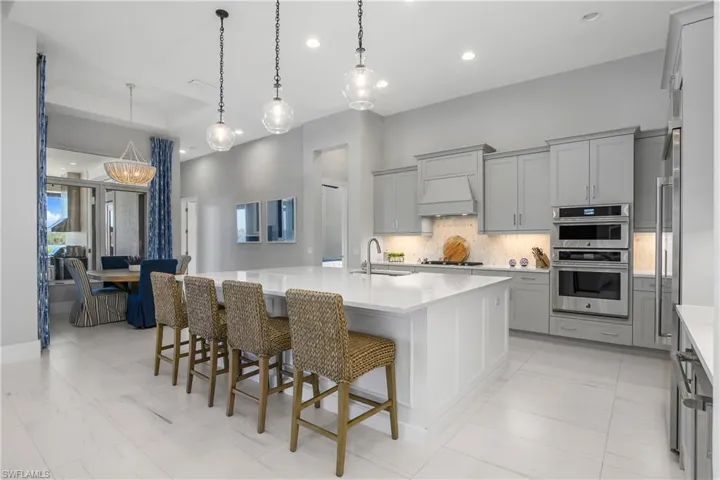 Kitchen includes professional grade JennAir appliances with natural gas cooktop double oven, refrigerator and wine cooler.