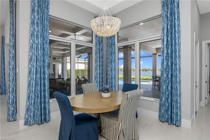 Cafe for additional dining sits just off the kitchen and overlooking outdoor pool and Wildblue Lake.