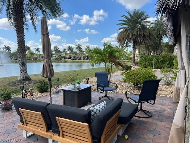 View of patio with an outdoor hangout area and a water view