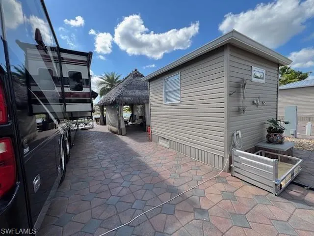 View of property exterior with a gazebo and a patio area