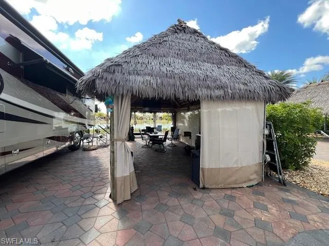 View of patio with outdoor dining area and a gazebo