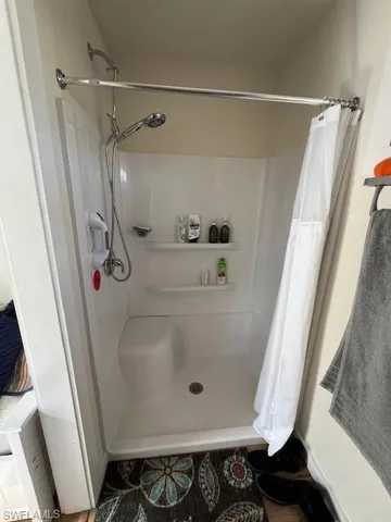 Full bath with a shower with curtain