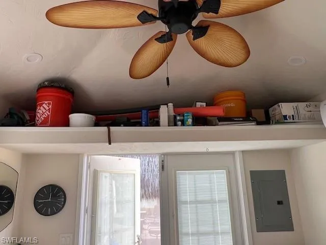 Room details with a ceiling fan and electric panel