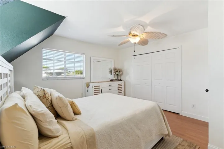 Bedroom featuring ceiling fan, vaulted ceiling, and light hardwood / wood-style flooring
