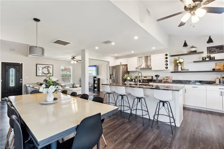 Dining space featuring dark hardwood / wood-style flooring, ceiling fan, and sink