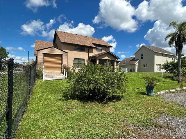 Back of house with a yard
