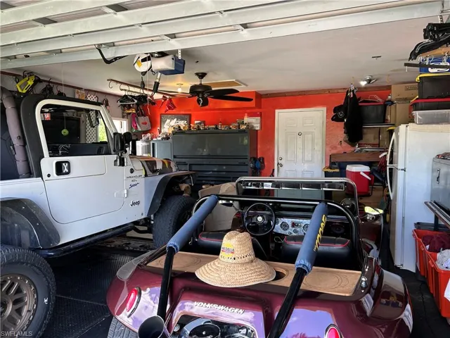 Garage featuring ceiling fan and a garage door opener