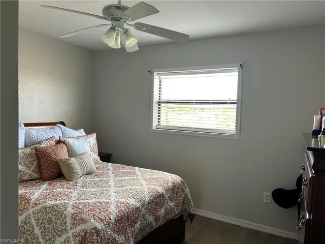 Bedroom featuring wood-type flooring and ceiling fan