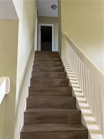 Stairway featuring hardwood / wood-style flooring