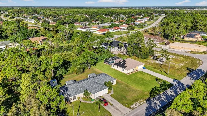 Aerial perspective of suburban area with a tree filled landscape