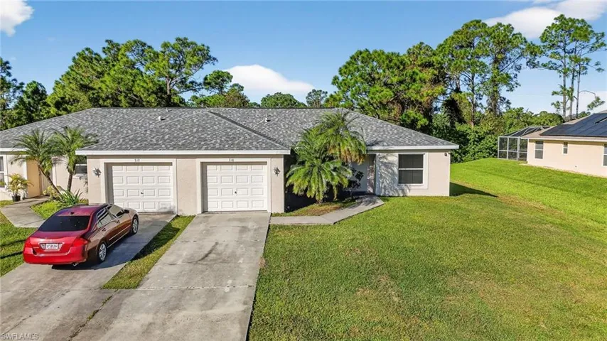 Single story home featuring roof with shingles, stucco siding, a front lawn, and concrete driveway