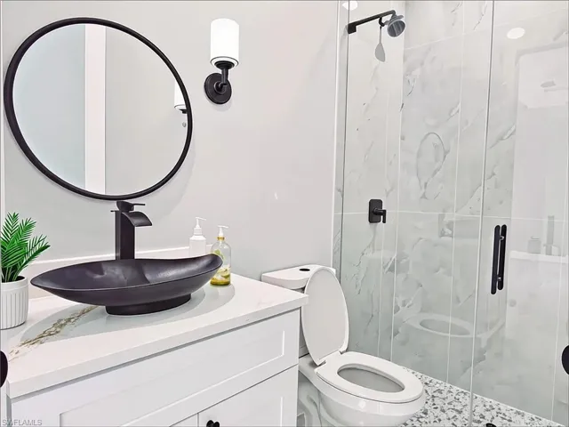 Full bath featuring a shower stall and vanity