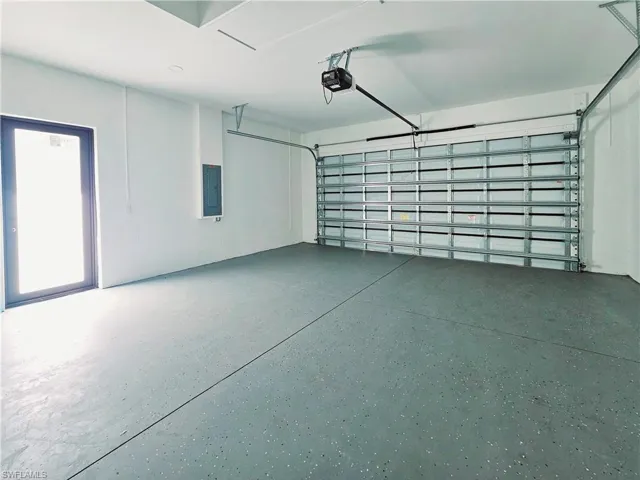 Garage with electric panel and a garage door opener
