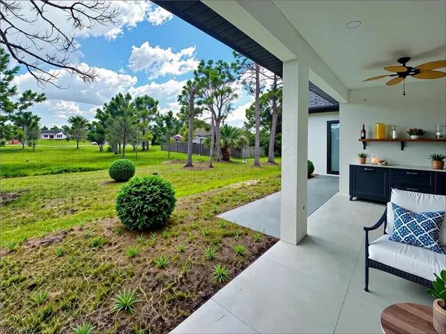View of yard with ceiling fan and a patio area