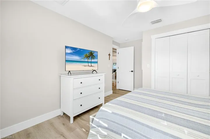 Bedroom with light wood-style floors and a closet