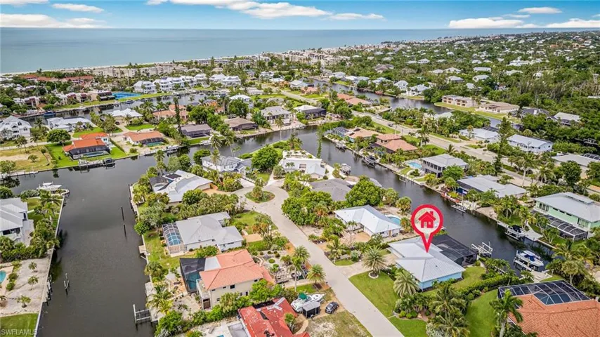 Aerial perspective of suburban area featuring a large body of water