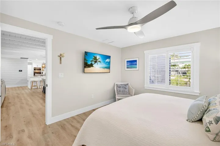 Bedroom with light wood finished floors and ceiling fan