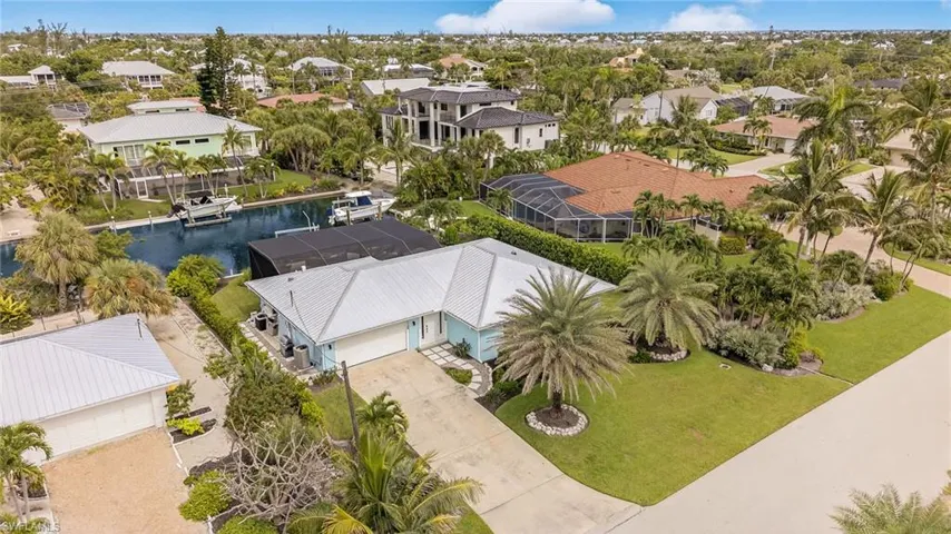 Aerial perspective of suburban area with a nearby body of water