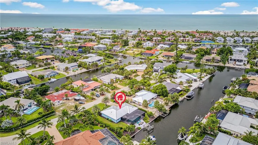 Aerial perspective of suburban area featuring a nearby body of water