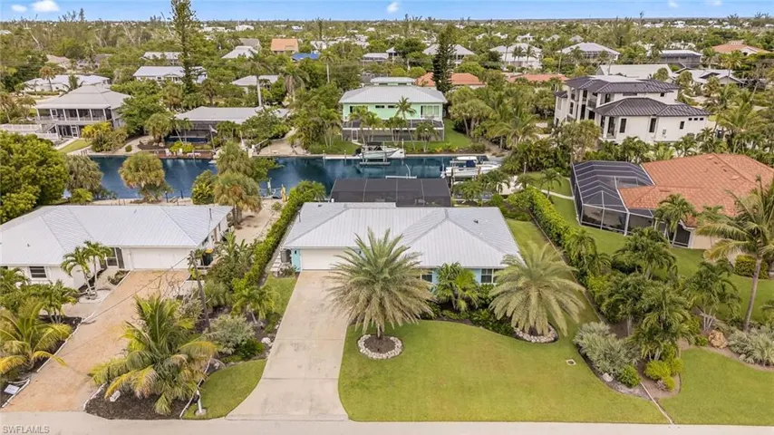 Aerial perspective of suburban area featuring a large body of water