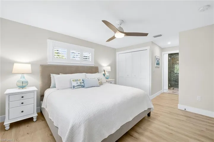 Bedroom featuring a closet, light wood-style flooring, and ceiling fan