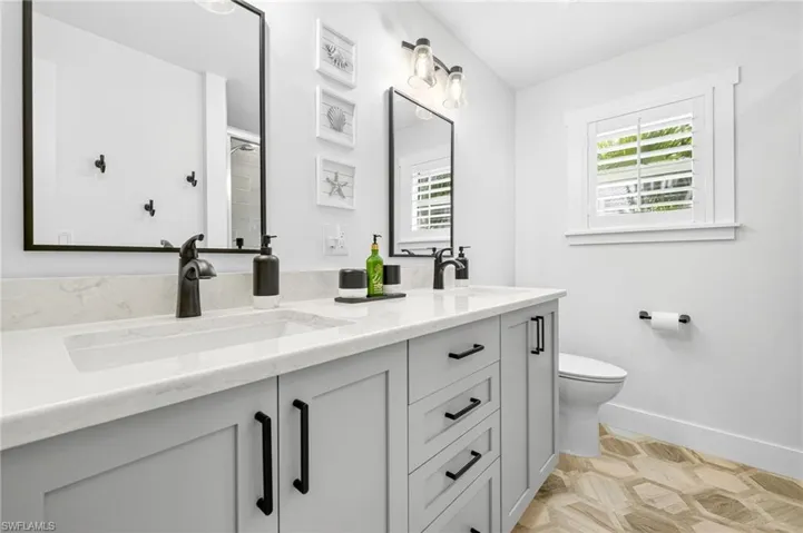Bathroom featuring double vanity and toilet