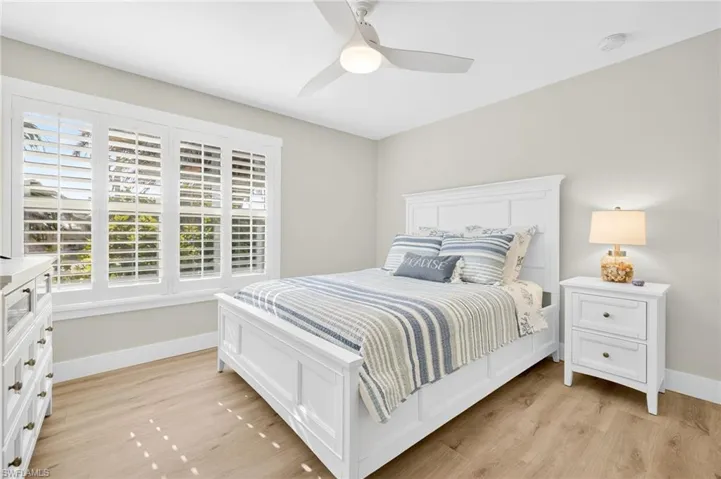 Bedroom with light wood-type flooring and a ceiling fan