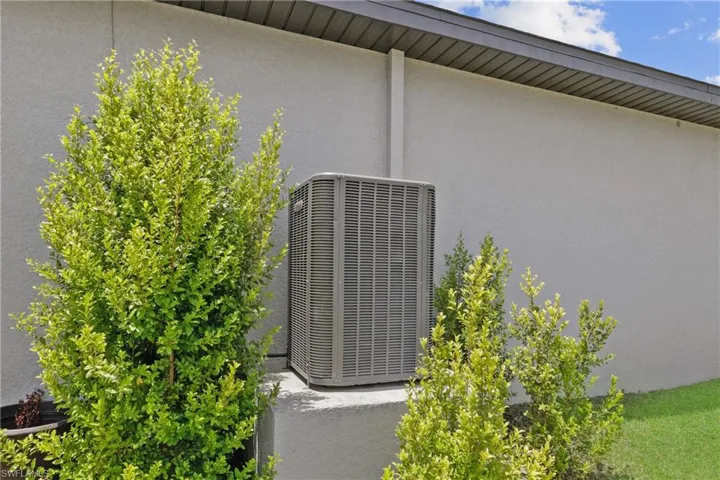 Lennox High Efficiency 15 Seer AC mounted up high on concrete pedestal