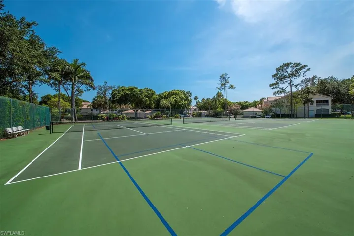View of sport court featuring community tennis/pickleball courts and fence