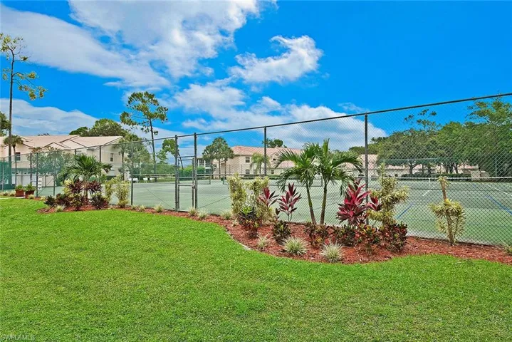 View of sport court featuring community tennis/pickleball courts and fence