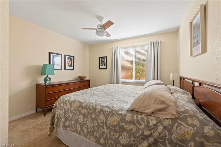 2nd Bedroom with tile patterned flooring, baseboards, and ceiling fan