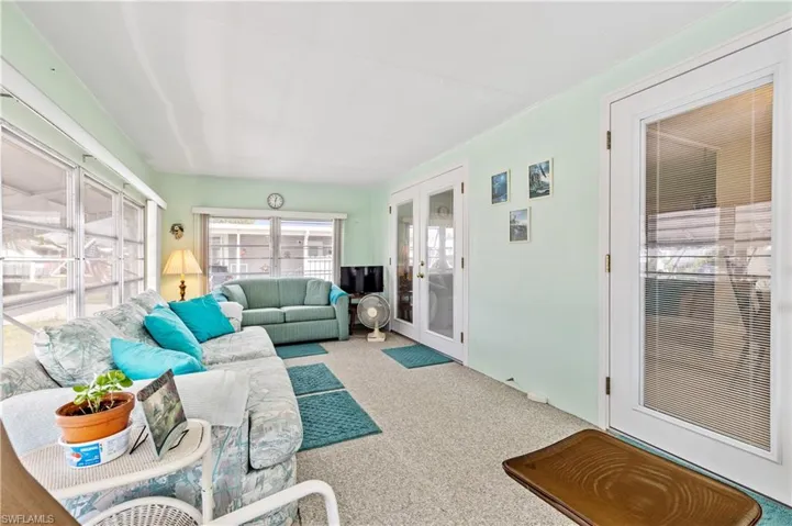 Sunroom with french doors and carpet flooring