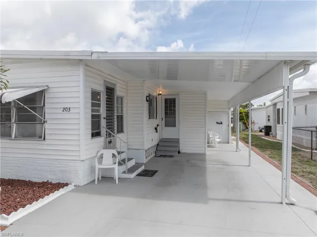 View of patio / terrace with entry steps and an attached carport