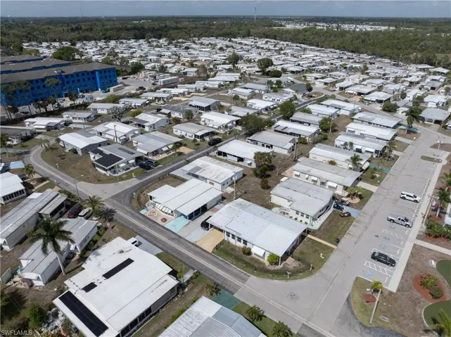 Aerial view of property and surrounding area with nearby suburban area