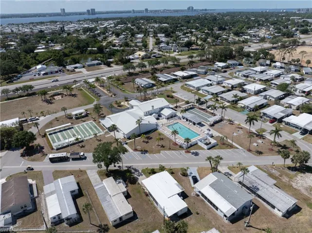 Aerial view of property's location with nearby suburban area and a pool area