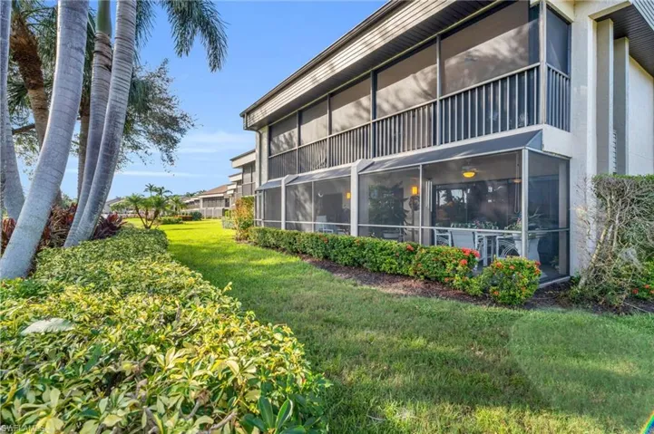 View of building exterior and lush landscaping
